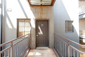 Entrance to property with stucco siding