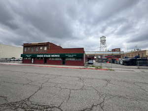 View of building exterior featuring uncovered parking