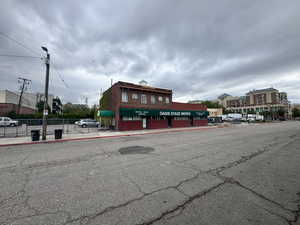 Exterior space featuring street lights, curbs, and sidewalks