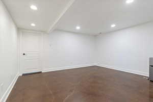 Basement rec room with concrete floors