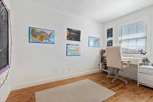 Office with hardwood flooring