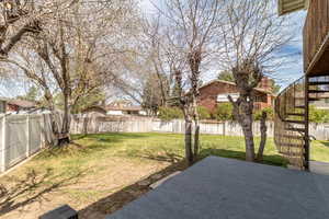 View of yard with a patio area, a fenced backyard, and stairs