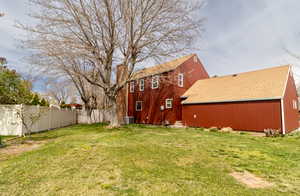 View of yard featuring central air condition unit and fence