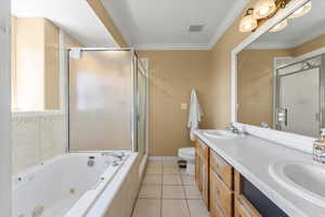 Full bathroom with visible vents, a jetted tub, a stall shower, and a sink