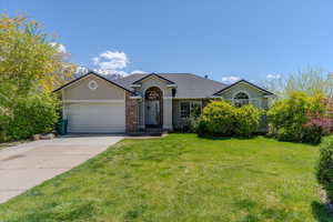 Single story home featuring roof with shingles, driveway, a garage, stucco siding, and a front lawn