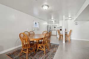 Dining room featuring light tile patterned floors and baseboards