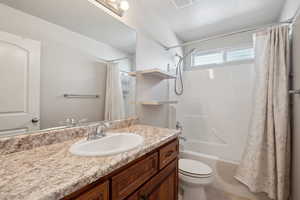 Bathroom featuring toilet, vanity, visible vents, tile patterned flooring, and shower / bathtub combination with curtain