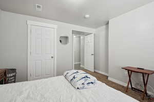 Carpeted bedroom with visible vents and baseboards