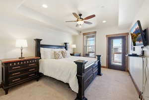 Bedroom with light colored carpet, a ceiling fan, and recessed lighting