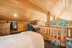 Bedroom with lofted ceiling, recessed lighting, log walls, wood-type flooring, and wood ceiling