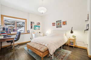 Bedroom with baseboards and wood finished floors