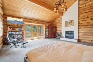 Bedroom featuring access to outside, log walls, wooden ceiling, and carpet floors