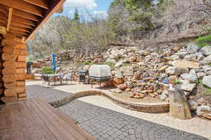 View of patio with a grill