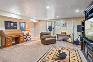 Living room featuring baseboards, carpet flooring, and recessed lighting