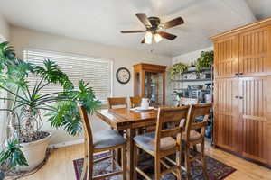 Dining space with light wood-type flooring and a ceiling fan