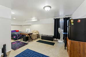 Interior space featuring baseboards, recessed lighting, and a textured ceiling