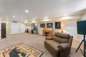 Living area featuring baseboards, carpet floors, and recessed lighting