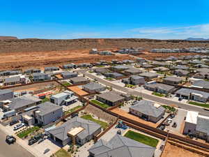 Aerial perspective of suburban area featuring a mountain backdrop and a desert landscape
