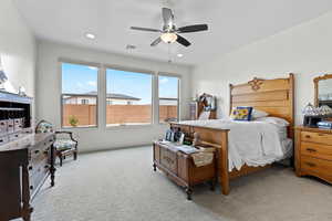 Bedroom with carpet flooring, ceiling fan, and recessed lighting