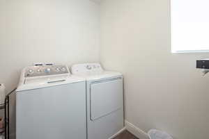 Laundry area featuring baseboards, laundry area, and washer and clothes dryer