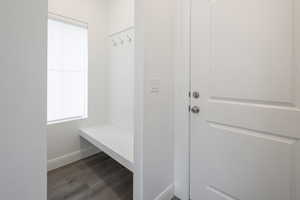 Mudroom featuring wood finished floors and baseboards