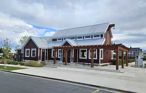 View of front of property featuring board and batten siding and metal roof