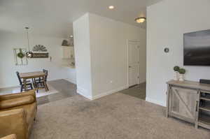 Living area featuring baseboards, carpet flooring, visible vents, and recessed lighting