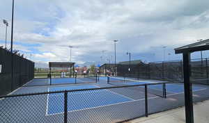 View of tennis court featuring fence