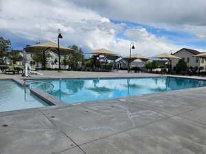 Community pool featuring a residential view, fence, and a patio
