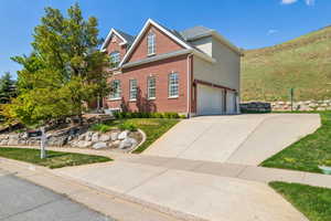 Traditional-style house featuring brick siding and driveway