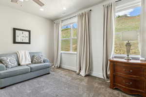 Carpeted living room featuring baseboards, ceiling fan, recessed lighting, and visible vents