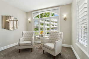 Sitting room featuring baseboards and carpet flooring