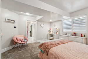 Carpeted bedroom with baseboards