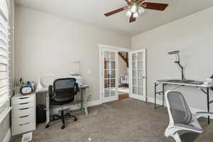 Office area featuring ceiling fan, french doors, visible vents, carpet floors, and baseboards
