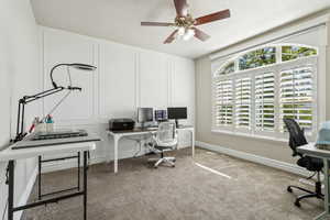 Home office featuring carpet floors, a ceiling fan, and baseboards