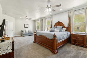 Carpeted bedroom featuring visible vents, recessed lighting, ceiling fan, and multiple windows