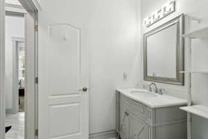 Bathroom featuring vanity and marble finish floor