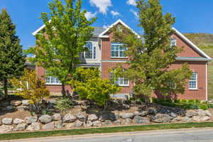 View of front of home featuring brick siding