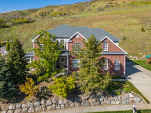 View of front of house with brick siding and a mountain view