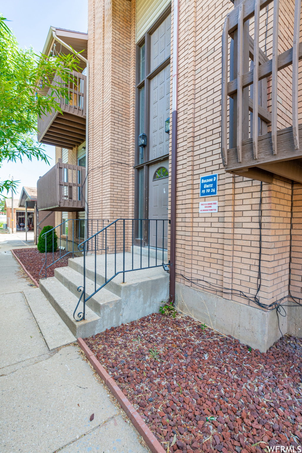 Doorway to property with brick siding