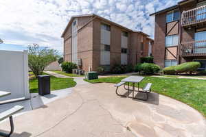View of community featuring a yard and a patio