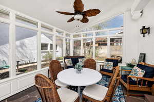 Sunroom / solarium featuring plenty of natural light, lofted ceiling, and ceiling fan