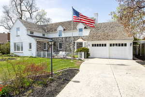 View of front of home with fence, concrete driveway, a garage, a front yard, and a chimney