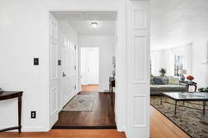 Entryway with wood finished floors and baseboards