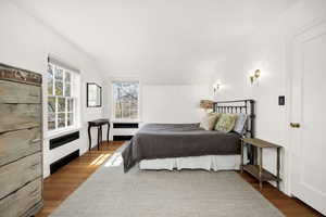 Bedroom featuring vaulted ceiling and wood finished floors