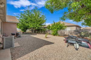 View of yard with a fenced backyard, a patio area, and cooling unit