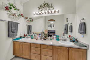 Bathroom featuring a sink and double vanity