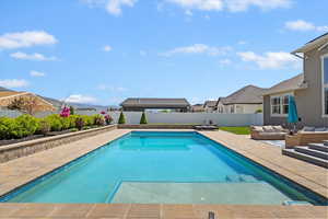 View of swimming pool featuring an outdoor hangout area, a patio, a fenced in pool, and a fenced backyard