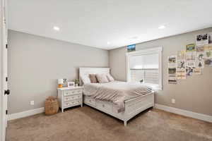 Bedroom featuring baseboards, carpet flooring, and recessed lighting