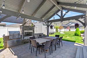 View of patio featuring fence, area for grilling, outdoor dining area, and a grill